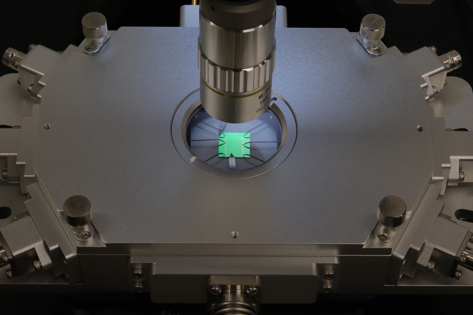 A Cortisonic chip beneath a microscope objective during characterisation